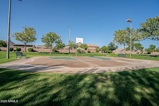 view of sport court featuring a lawn