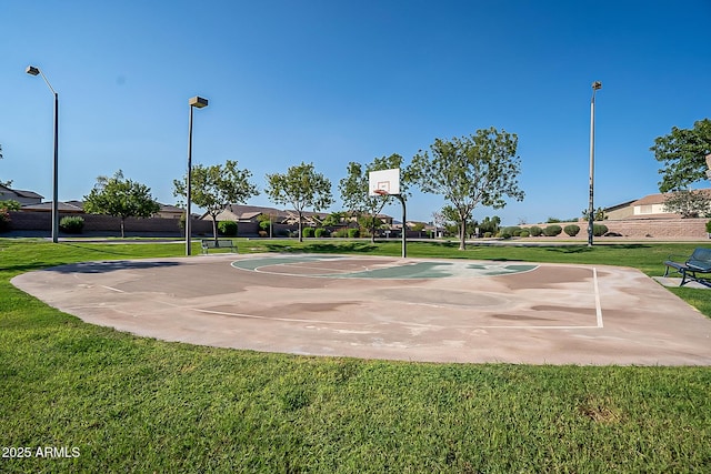 view of sport court with a yard