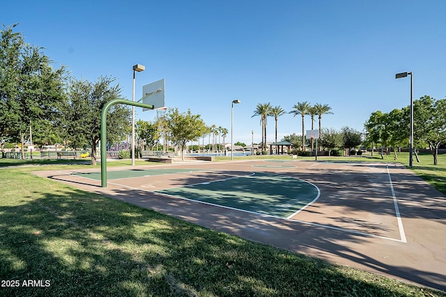 view of sport court featuring a lawn