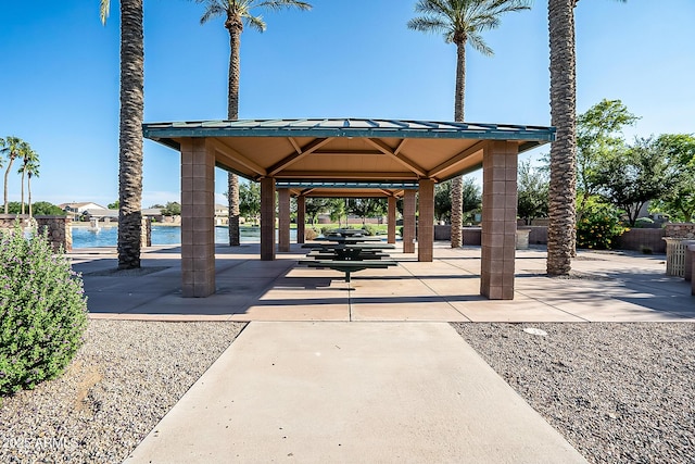 surrounding community with a gazebo and a water view