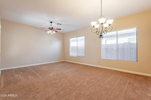 unfurnished room with carpet floors and ceiling fan with notable chandelier