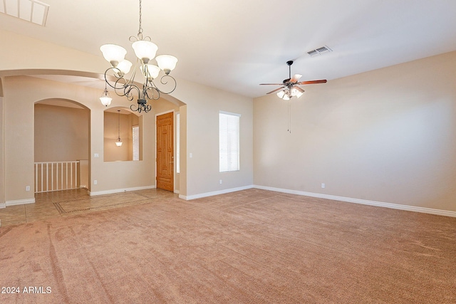 carpeted spare room with ceiling fan with notable chandelier