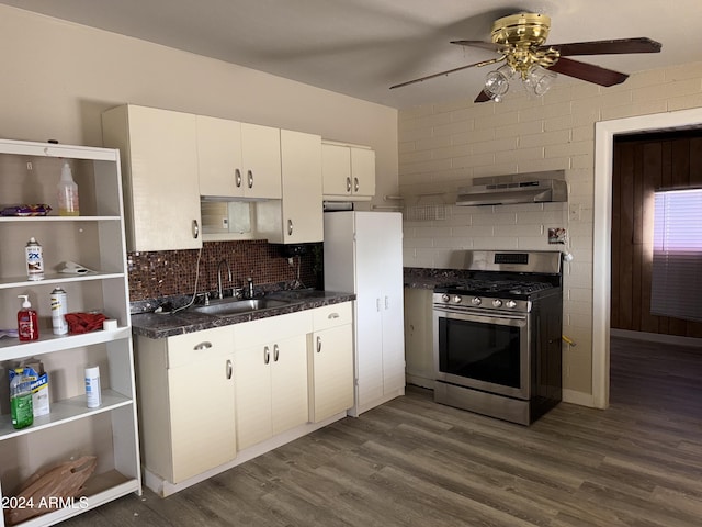 kitchen featuring extractor fan, ceiling fan, sink, stainless steel range oven, and white cabinets