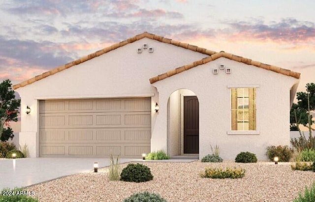 mediterranean / spanish-style house featuring a garage