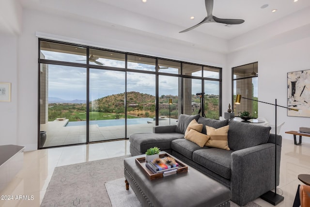 tiled living room featuring recessed lighting, a mountain view, and a ceiling fan