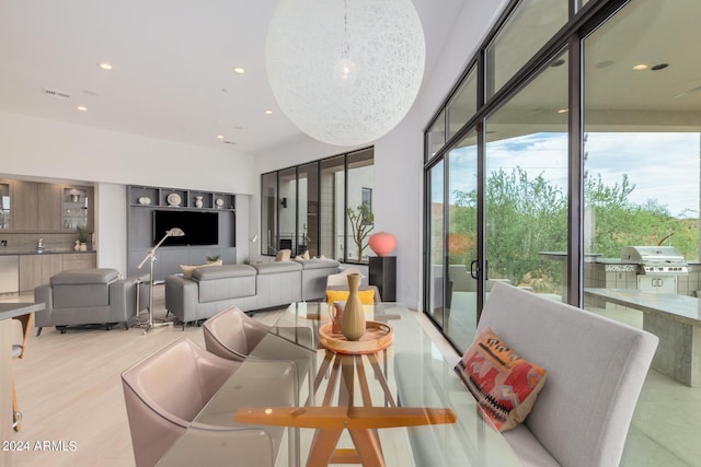 dining room with light wood finished floors, recessed lighting, a healthy amount of sunlight, and visible vents