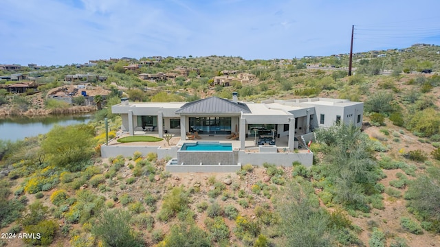 back of house with a patio, an outdoor living space, an outdoor pool, stucco siding, and a gazebo