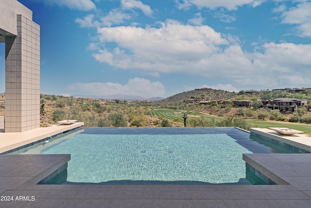 view of swimming pool featuring a mountain view