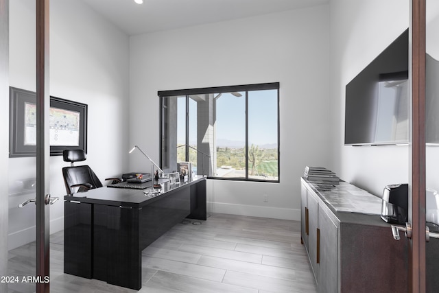 office area with light wood-type flooring and baseboards