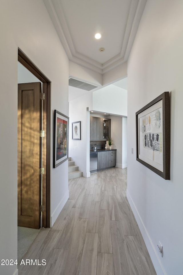 hallway featuring recessed lighting, stairway, light wood-style flooring, and baseboards