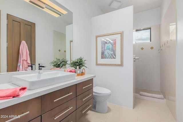 full bath featuring vanity, tile patterned floors, toilet, and walk in shower