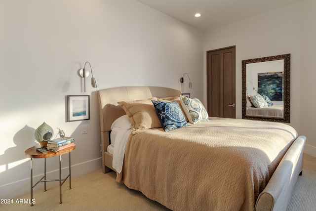 bedroom with recessed lighting, light colored carpet, and baseboards