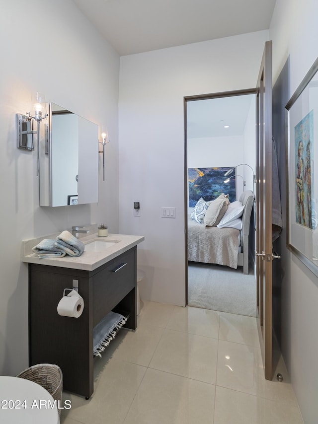 ensuite bathroom with tile patterned flooring, ensuite bathroom, toilet, and vanity