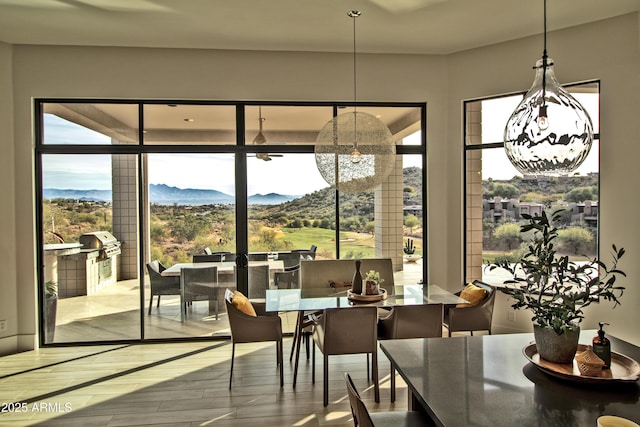 dining space with a mountain view and wood finished floors