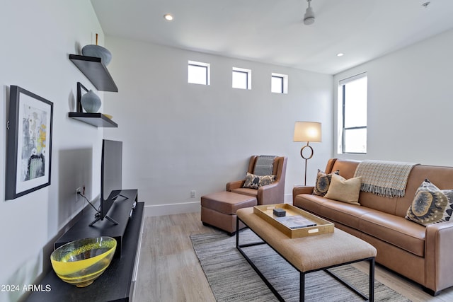 living area with recessed lighting, baseboards, and light wood-style floors