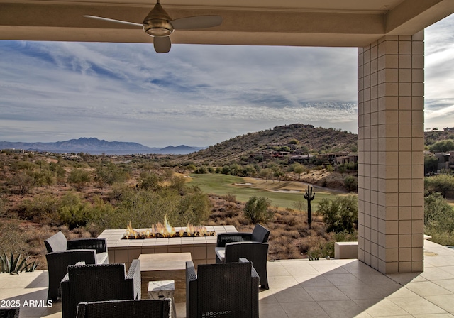 view of patio featuring a fire pit and a mountain view