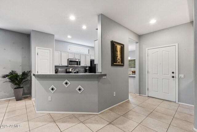 20450 N Shadow Mountain Dr, Surprise, AZ 85374 - kitchen with appliances with stainless steel finishes, white cabinetry, light tile patterned flooring, baseboards, and recessed lighting