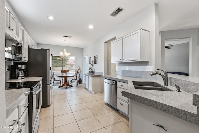 20450 N Shadow Mountain Dr, Surprise, AZ 85374 - kitchen featuring appliances with stainless steel finishes, a sink, a chandelier, light tile patterned flooring, and recessed lighting