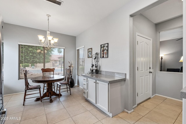 20450 N Shadow Mountain Dr, Surprise, AZ 85374 - dining area with a chandelier, light tile patterned flooring, and baseboards