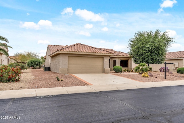 20450 N Shadow Mountain Dr, Surprise, AZ 85374 - mediterranean / spanish house featuring an attached garage, concrete driveway, a tile roof, stucco siding, and central air condition unit