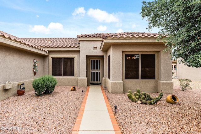 20450 N Shadow Mountain Dr, Surprise, AZ 85374 - view of exterior entry with stucco siding and a tile roof