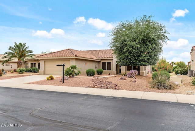 20450 N Shadow Mountain Dr, Surprise, AZ 85374 - view of front facade with a tiled roof, an attached garage, stucco siding, concrete driveway, and central air condition unit