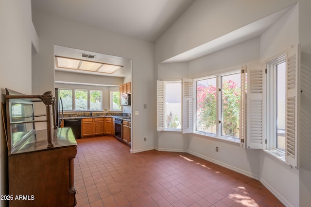 1226 E Greenway Cir, Mesa, AZ 85203 - kitchen featuring stainless steel appliances, tile patterned flooring, a sink, dark countertops, and baseboards