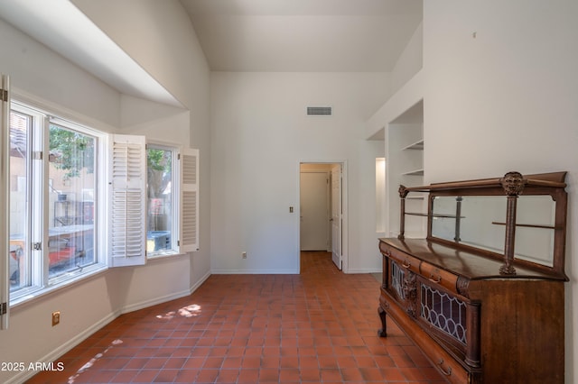 1226 E Greenway Cir, Mesa, AZ 85203 - hallway featuring a high ceiling, baseboards, and tile patterned flooring