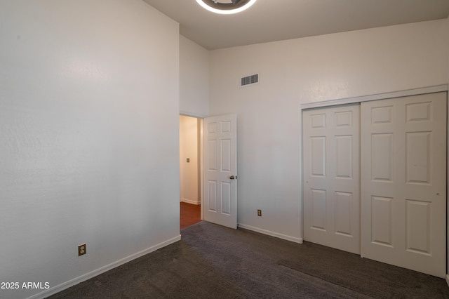 1226 E Greenway Cir, Mesa, AZ 85203 - unfurnished bedroom with dark colored carpet, baseboards, high vaulted ceiling, and a closet