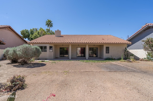1226 E Greenway Cir, Mesa, AZ 85203 - back of property with a tiled roof, a chimney, a patio, and stucco siding