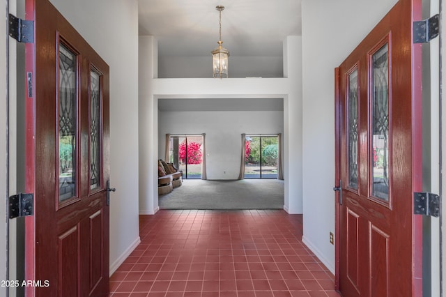 1226 E Greenway Cir, Mesa, AZ 85203 - entrance foyer with dark carpet, baseboards, and dark tile patterned floors