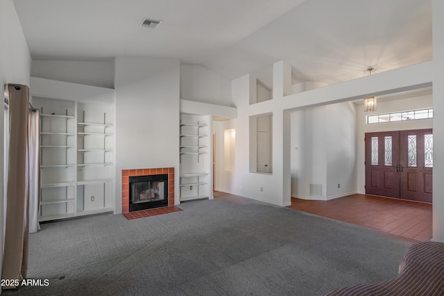 1226 E Greenway Cir, Mesa, AZ 85203 - unfurnished living room with a tiled fireplace, built in shelves, carpet floors, baseboards, and high vaulted ceiling