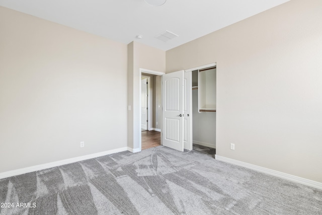 unfurnished bedroom with a closet and carpet