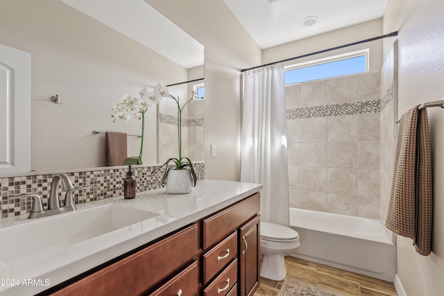 full bathroom with tasteful backsplash, toilet, vanity, hardwood / wood-style flooring, and shower / bathtub combination with curtain