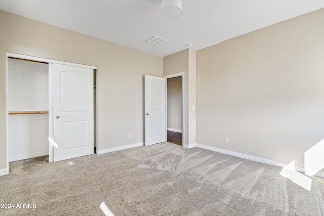 unfurnished bedroom featuring a closet and carpet