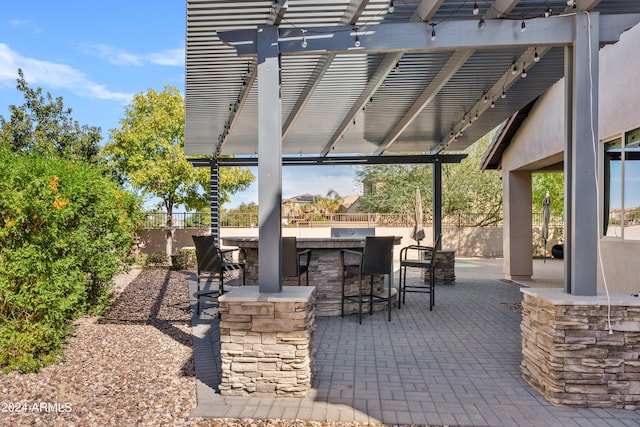 view of patio / terrace with a pergola and an outdoor bar