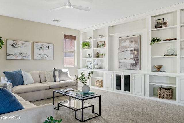 living room with light carpet, built in features, and ceiling fan