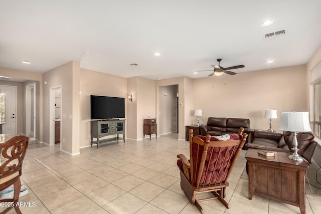 living area featuring light tile patterned floors, a ceiling fan, visible vents, and recessed lighting
