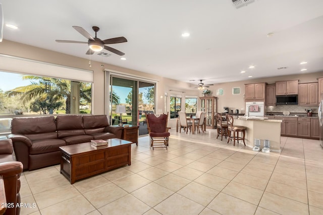 living area featuring ceiling fan, light tile patterned flooring, and recessed lighting