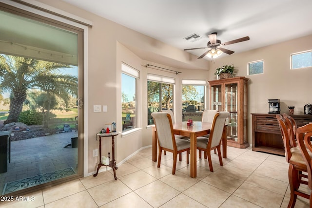 dining space featuring a healthy amount of sunlight, light tile patterned floors, ceiling fan, and visible vents