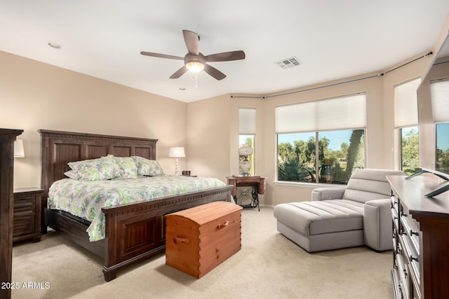 bedroom with light colored carpet, visible vents, and ceiling fan
