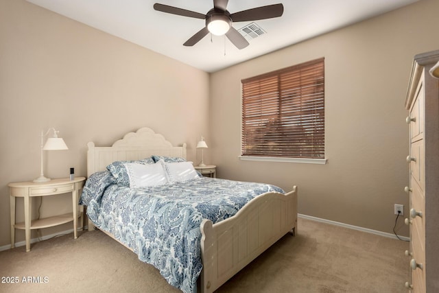 bedroom with light carpet, ceiling fan, visible vents, and baseboards