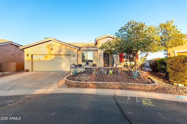 view of front facade with driveway, a tile roof, a garage, and stucco siding