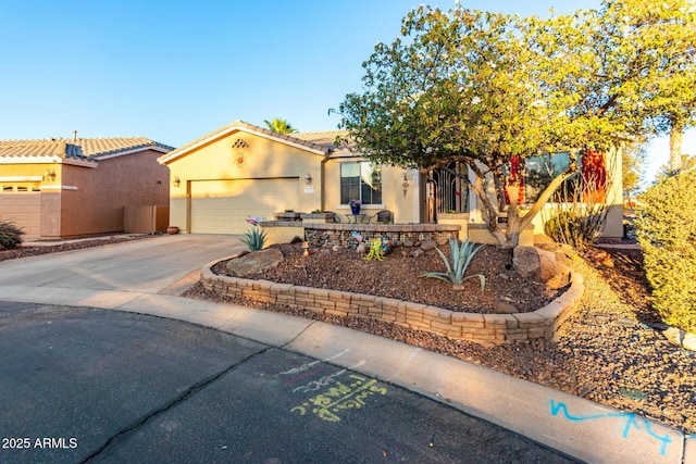 view of front of home with concrete driveway, an attached garage, a tile roof, and stucco siding