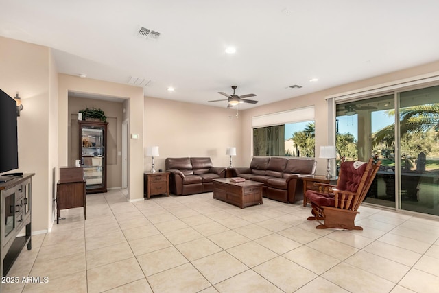living area with light tile patterned floors, ceiling fan, visible vents, and recessed lighting