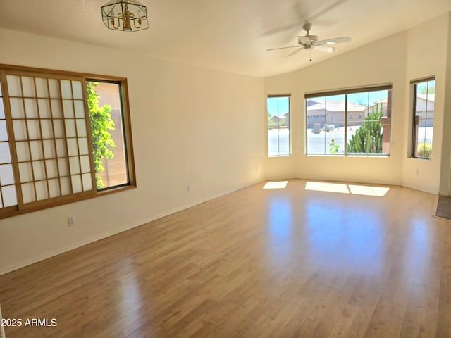 unfurnished room featuring ceiling fan, lofted ceiling, and light wood-type flooring