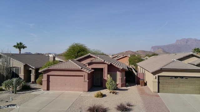 view of front of house with a garage and a mountain view