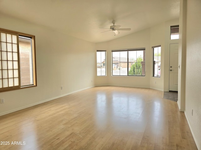 unfurnished room featuring lofted ceiling, ceiling fan, and light hardwood / wood-style flooring