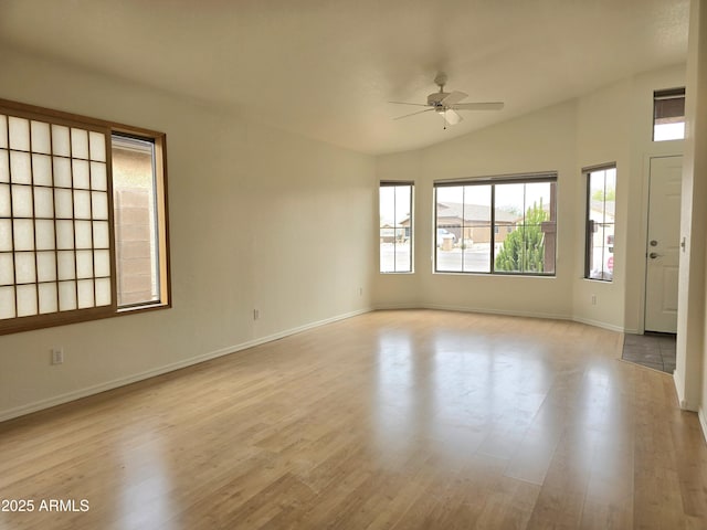 unfurnished room with vaulted ceiling, light hardwood / wood-style floors, and ceiling fan