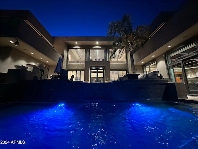 view of pool at night